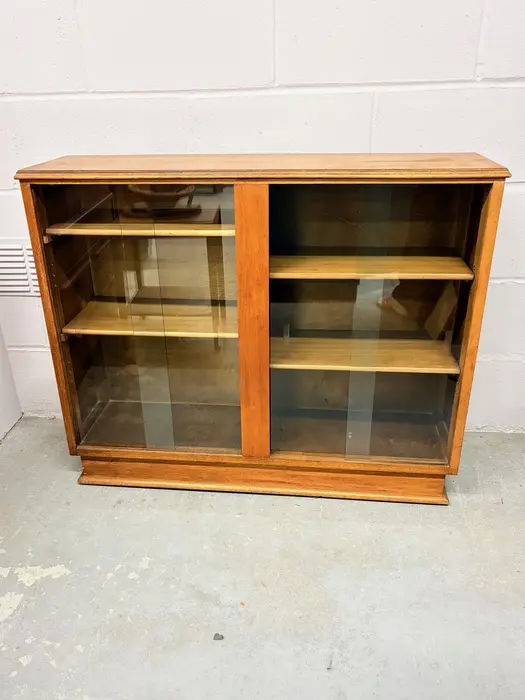 Mid-century glazed bookcase with sliding glass doors