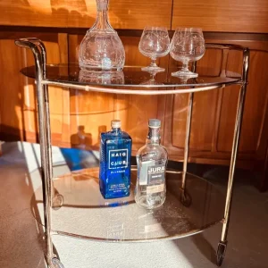 Mid-century oval bar cart with smoked glass and brass finish